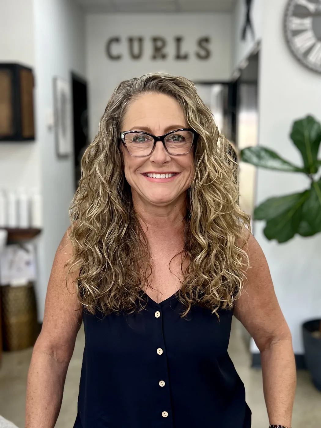 Cindy Latter, owner of A Curl’s Best Friend, smiling in the salon